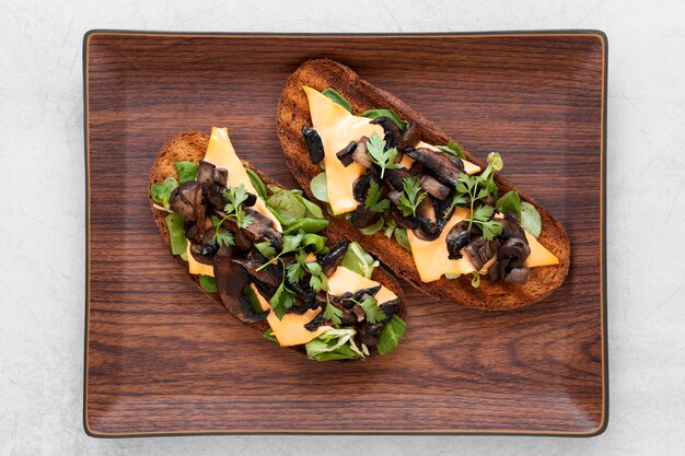 Arrangement of delicious sandwiches on wooden board