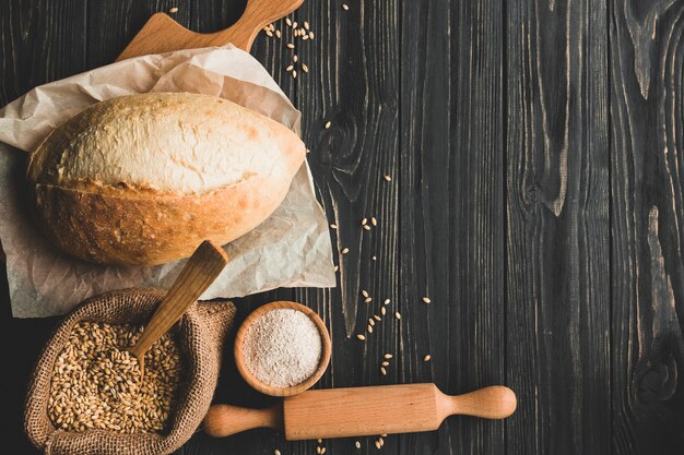 Arrangement of delicious wheat bun on wood