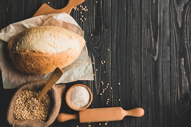 Arrangement of delicious wheat bun on wood