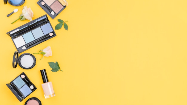 Free photo arrangement of different cosmetics with copy space on yellow background