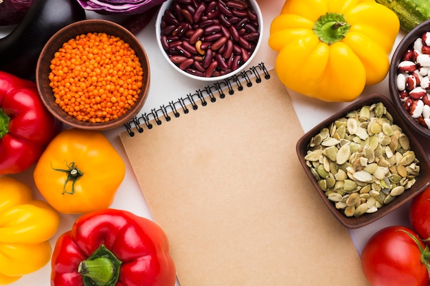 Arrangement of different vegetables with empty notepad