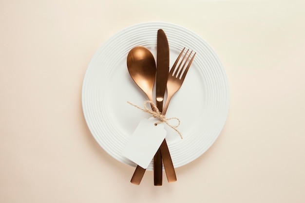 Arrangement of elegant tableware with empty tag