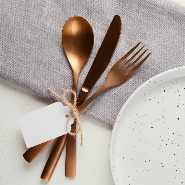 Arrangement of elegant tableware with empty tag