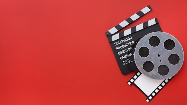 Arrangement of film elements on red background with copy space
