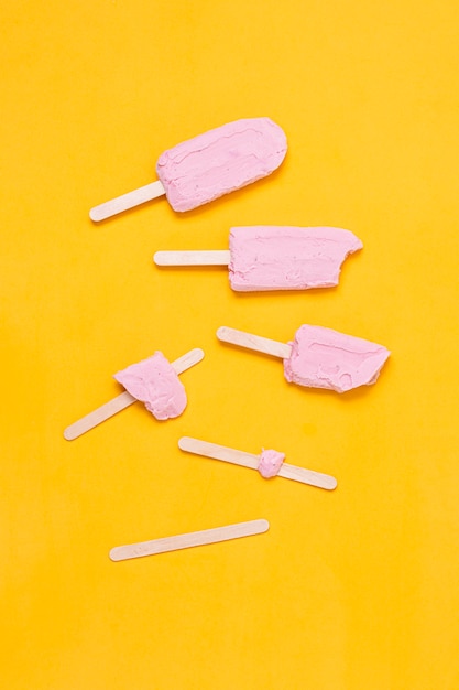 Arrangement flat lay stages of pink ice cream on stick