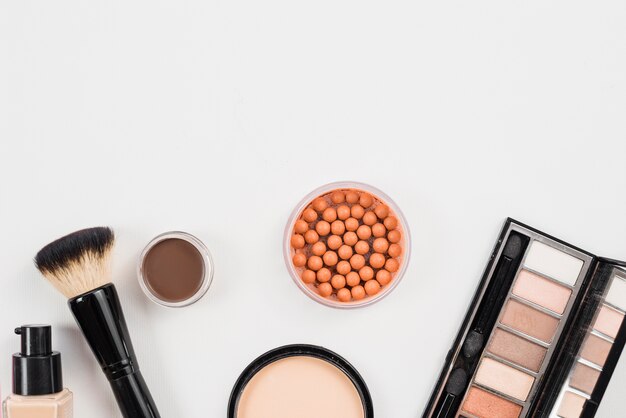 Arrangement from cosmetic beauty products laying on white background