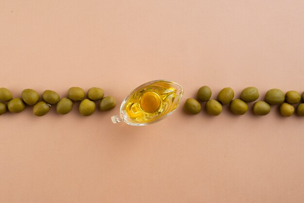 Arrangement of green olives with olive oil in middle