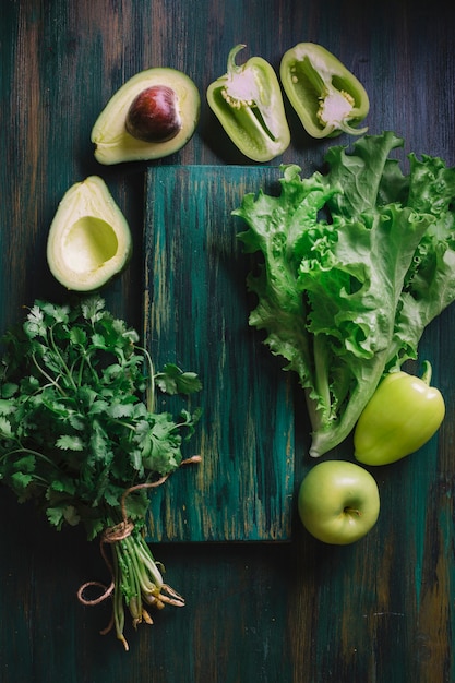 Arrangement of green vegetables and a cutting board