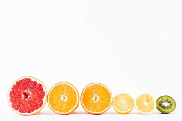 Arrangement of half fresh tropical fruits