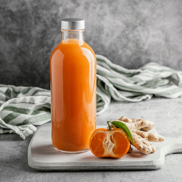 Arrangement of healthy drink in glass bottle