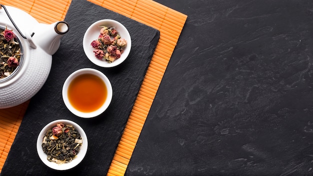 Arrangement of herbal tea and it's ingredient on slate stone