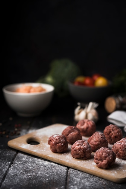 Arrangement of meatballs on wooden board