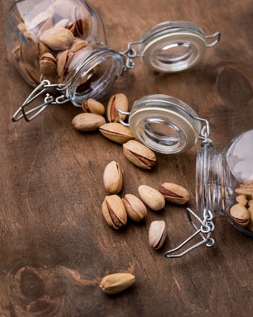 Free photo arrangement of overturned jars filled with pistachos