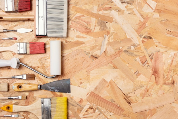 Arrangement of paint brushes on wooden background