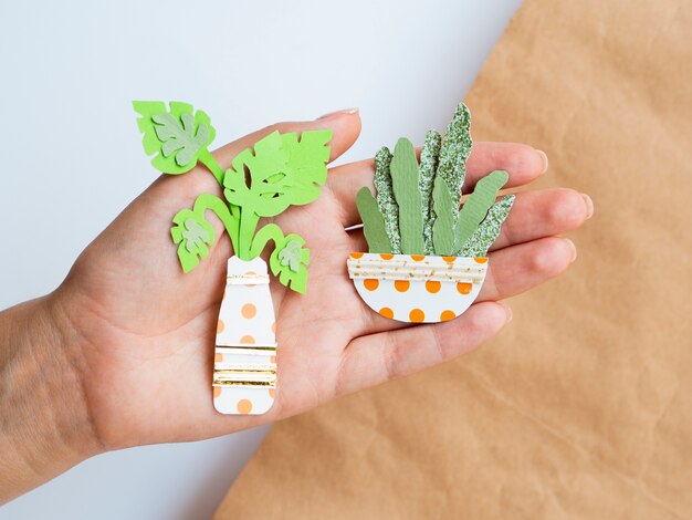 Arrangement of paper plants held in hand