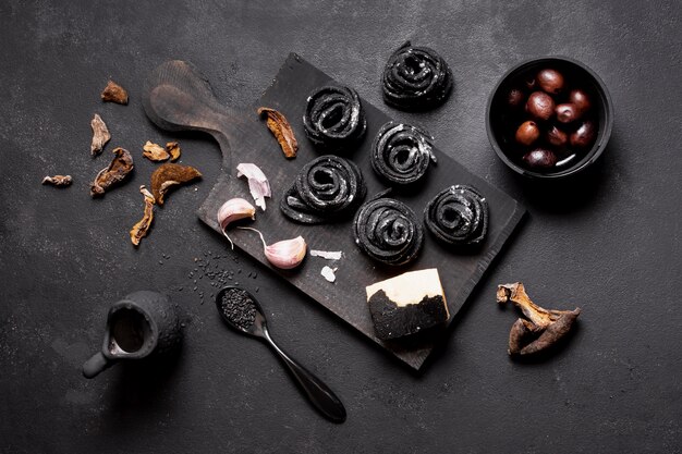 Arrangement of pasta and olives on cutting board