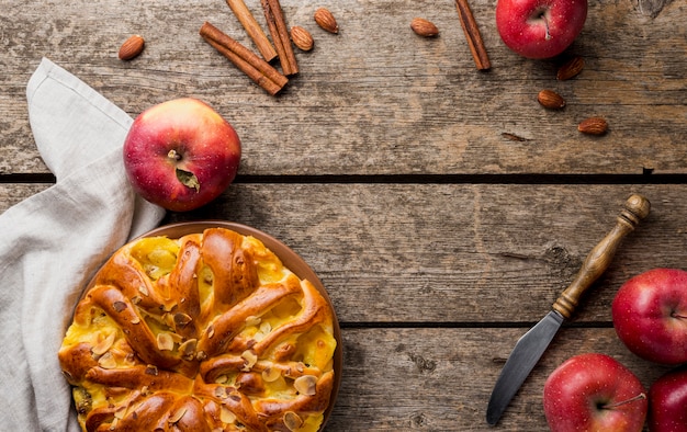 Arrangement of pie and apples with copy space background top view