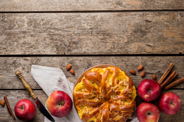 Arrangement of pie and apples with copy space background