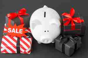 Free photo arrangement of piggy bank and gift boxes