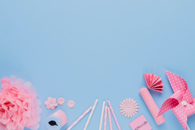 Free photo arrangement of pink craft art and equipment on blue backdrop