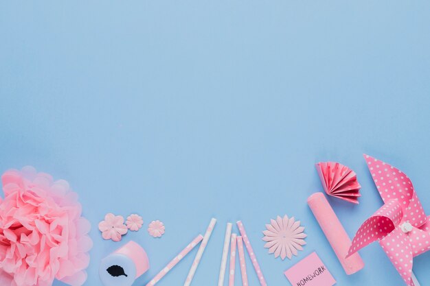 Arrangement of pink craft art and equipment on blue backdrop
