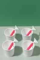 Free photo arrangement of pink razor blades and cup