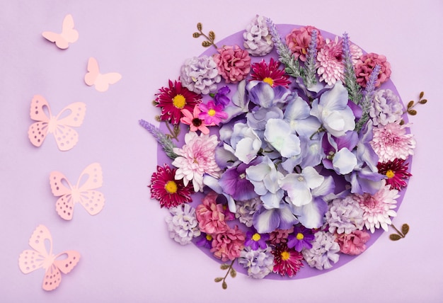 Arrangement of pretty flowers with purple background