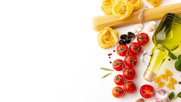Arrangement of raw pasta and ingredients with copy space