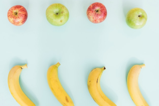 Arrangement of ripe bananas and apples