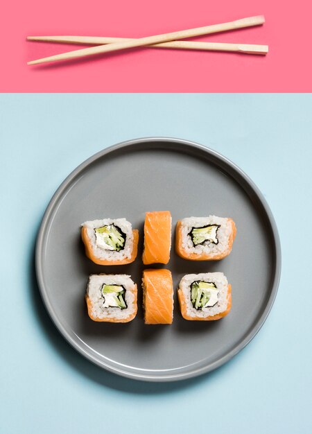 Arrangement of sushi rolls with chopsticks and soy sauce