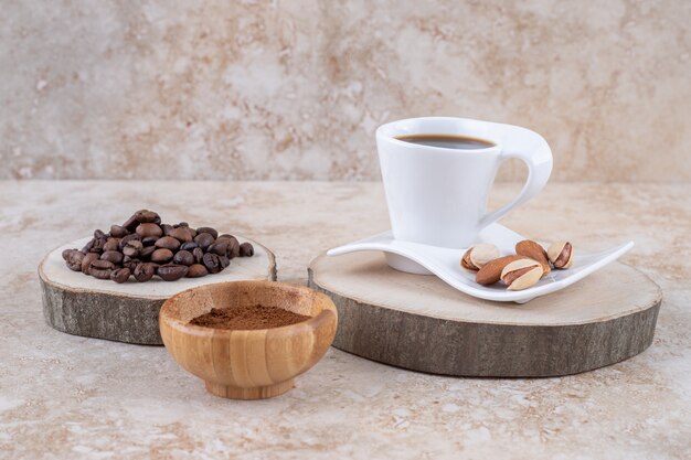 An arrangement of various forms of coffee with almonds and pistachios 