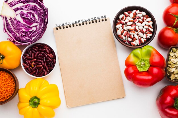Arrangement of vegetables on empty notepad