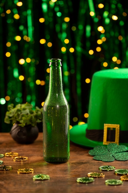 Arrangement with beer bottle and green hat