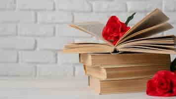 Free photo arrangement with books and flowers