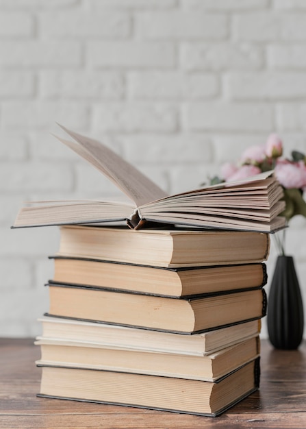 Arrangement with books stack indoors