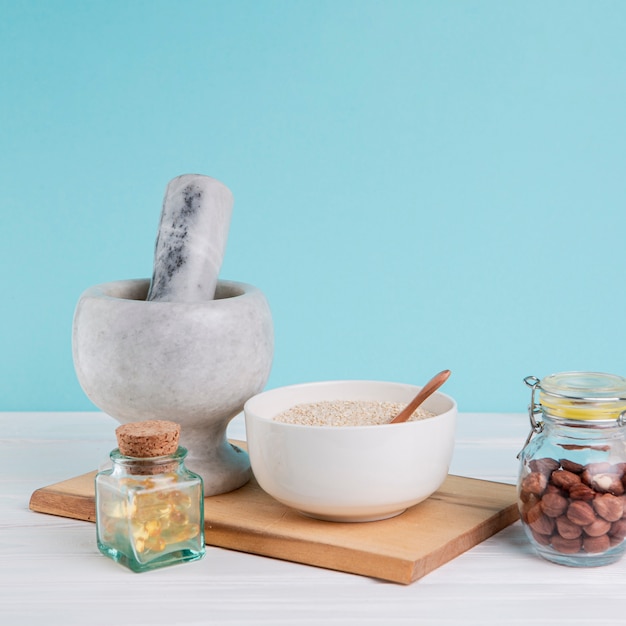 Free photo arrangement with bowl and jar with nuts