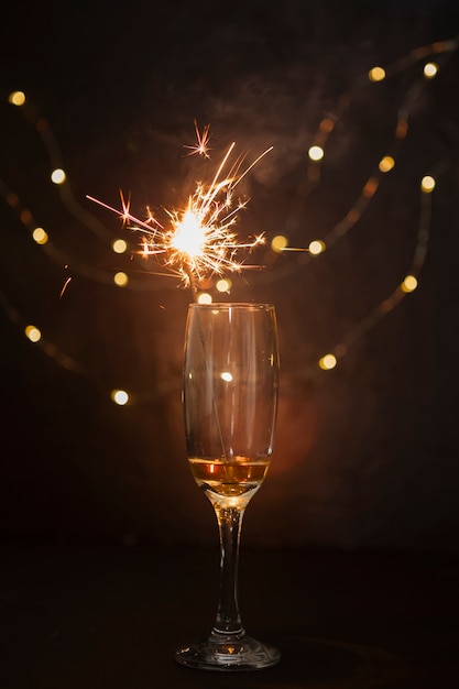 Arrangement with champagne glass and fireworks