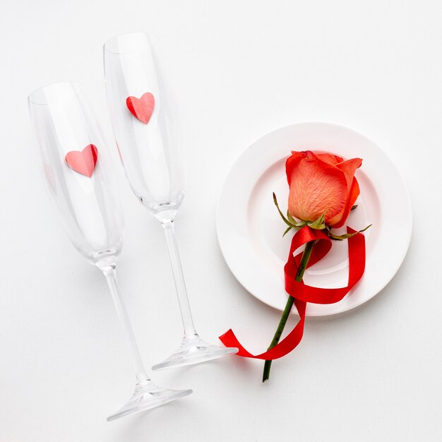 Arrangement with champagne glasses on white background