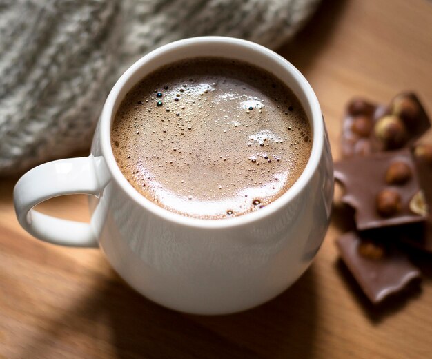 Arrangement with cup of coffee and chocolate close-up