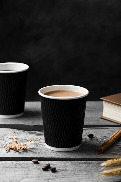 Arrangement with cup of coffee on wooden background