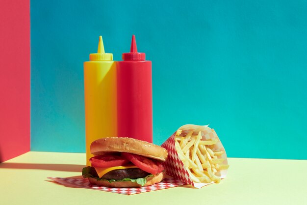 Arrangement with delicious burger and sauce bottles