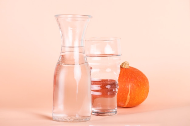 Arrangement with different sized glasses and pumpkin