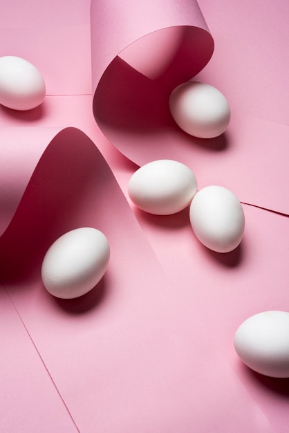 Arrangement with eggs on pink background