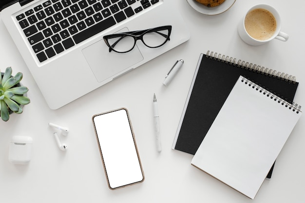 Free photo arrangement with empty notepad on desk