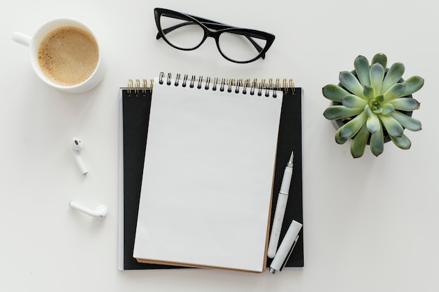 Arrangement with empty notepad on desk