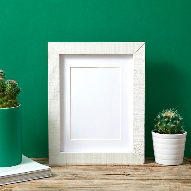 Arrangement with empty white frame indoors