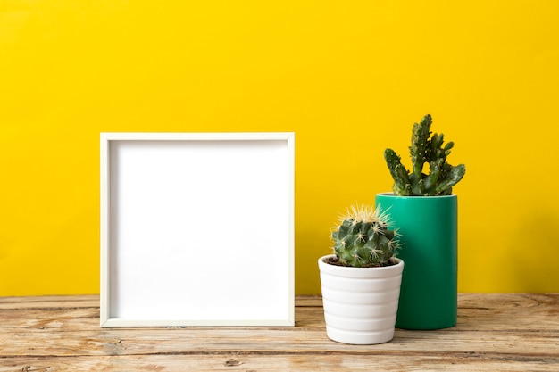 Arrangement with empty white frame on table