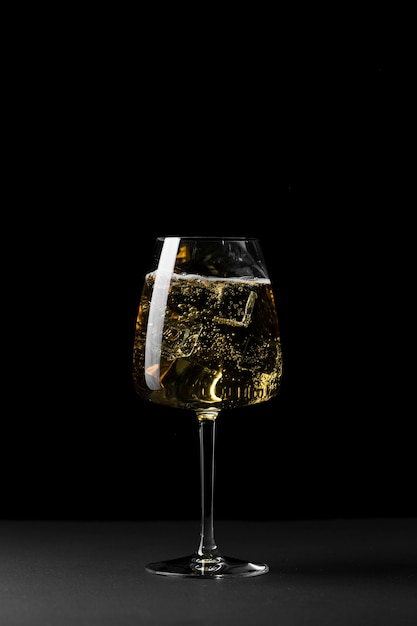 Arrangement with glass and dark background