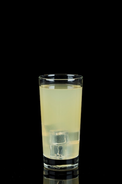 Arrangement with glass of lemonade in the dark