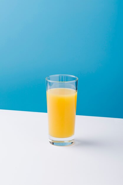 Arrangement with glass of orange juice